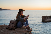 Young Woman Using Smartphone On Beach During Sunset, Ibiza