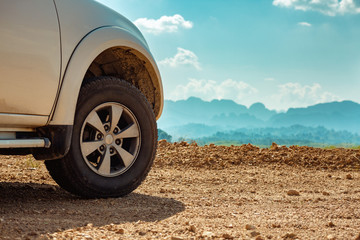 Unrecognizable modern 4x4 car on dirty road