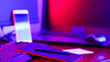 Leinwandbild Motiv Freelancer workplace in neon light. Computer, graphics tablet and smartphone on the table. Place for creativity in blue pink light. Widescreen