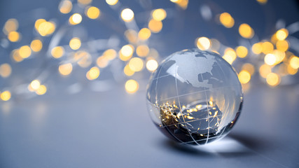 New year 2025. Earth ball globe on a blue silver background with golden lights. Christmas tree ball.