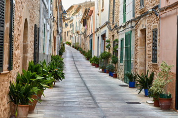 Naklejka na meble Typical Mallorcan village street with pots and plants on the sides
