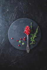 Wall Mural - Fresh juicy pomegranate - whole and cut on a black vintage background, top view, horizontal, with copy space