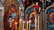 Wax Burning Candles In An Orthodox Church On The Icon Background.