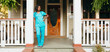 © Gerald Carter/Creative Flame - Healthcare professional leaning against pillar in front of house