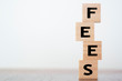 © raquel - Fees word written on wooden cubes