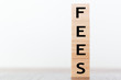 © raquel - Fees word written on wooden cubes