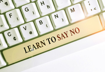 Writing note showing Learn To Say No. Business concept for decline or refuse few things before you destroy yourself White pc keyboard with note paper above the white background