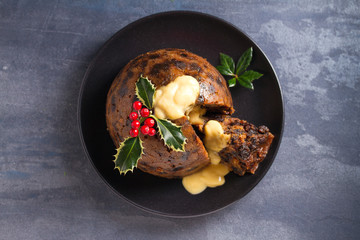 Wall Mural - Christmas pudding decorated with sprig of holly. Cristmas decorations. View from above, top