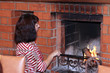 © sanek70974 - woman stands by the fireplace