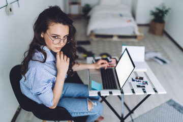 Sticker - Woman with netbook sitting at table in home office