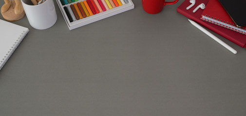 Top view of modern workplace with laptop computer and office supplies on dark grey table