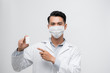 © makistock - Handsome Male Doctor holding empty white or blank Pills bottle. standing isolated over white background