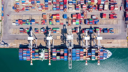Wall Mural - 4k, Time lapse, Aerial view container ship carrying container in import export business logistic and transportation of international by container ship in the open sea.