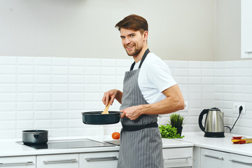 Wall Mural - man cooking in kitchen