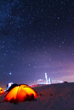 Fototapeta Kosmos - Great bright campsite with colorful tourist tents, on top in the Ukrainian Carpathian Mountains, at night with views of the stars and the Milky Way	