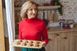 © Viacheslav Yakobchuk - Pleased mature female demonstrating her homemade pastries