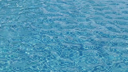 Wall Mural - water rippled pattern on blue water surface in swimming pool.