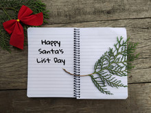 Happy Santa's List Day Text Written On Notepad With Some Ornament Background