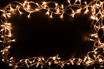 Christmas lights border. Christmas background with lights and free text space. Christmas lights on black background. New Year.