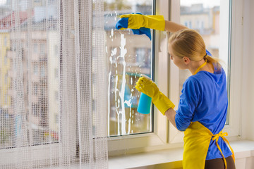 Woman cleaning window at home