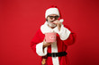 © ViDi Studio - Elderly gray-haired mustache bearded Santa man in Christmas hat, 3d imax glasses isolated on red background. New Year 2020 celebration concept. Mock up copy space. Watching movie film holding popcorn.