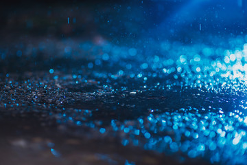 Wall Mural - Autumn background with bokeh from the drops of rain, bright blue light is refracted through drops of water