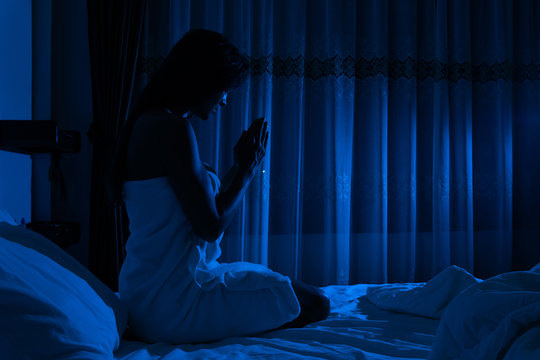 Young girl praying before going to sleep