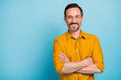 Portrait of charming mature man true boss feel content emotions wear yellow shirt isolated over blue color background