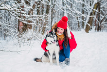 Girl With Her Cute Dog Husky In The Winter Park