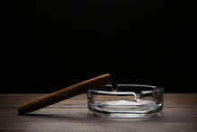 Cigar And Ashtray On Dark Background With Copy Space