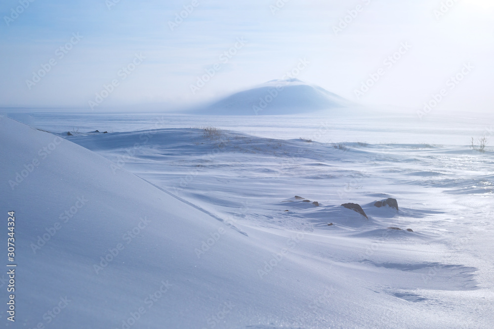 Winter arctic landscape with snow covered tundra and hills. Very cold frosty weather in April in the far north of Russia. Location place: Chukotka, Siberia, Russian Far East. Polar region. - obrazy, fototapety, plakaty 