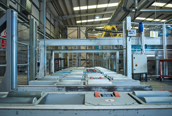 An empty industrial roller conveyor belt in a fully automated factory. roller conveyor to easily move heavy industrial goods around without the need for humans.future of industrial manufacture.