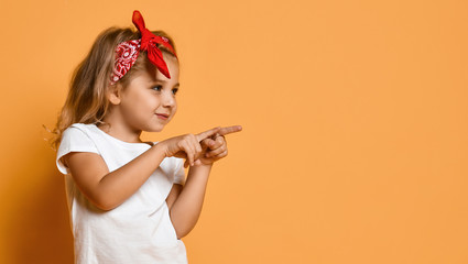 little kid girl in white blank white t-shirt and red headband pointing both fingers at free copy spa