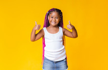 Pretty Little African American Girl Gesturing Thumbs Up And Smiling