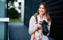 Beautiful Smiling Young Woman Photographs On Camera
