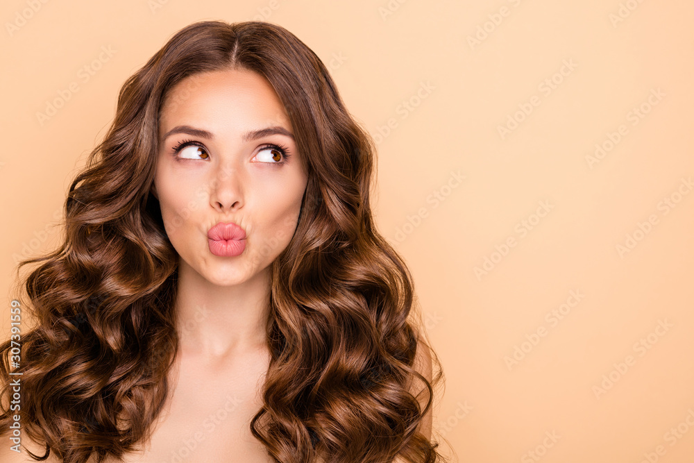 Close-up portrait of her she nice-looking attractive sweet gorgeous girlish curious wavy-haired girl looking aside sending kiss pout lips copy space isolated over beige pastel color background - obrazy, fototapety, plakaty 
