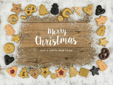 Fototapeta Do przedpokoju - a lot of different christmas cookies on white snow and wooden background