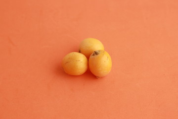 delicious yellow medlar fruit with colorful background