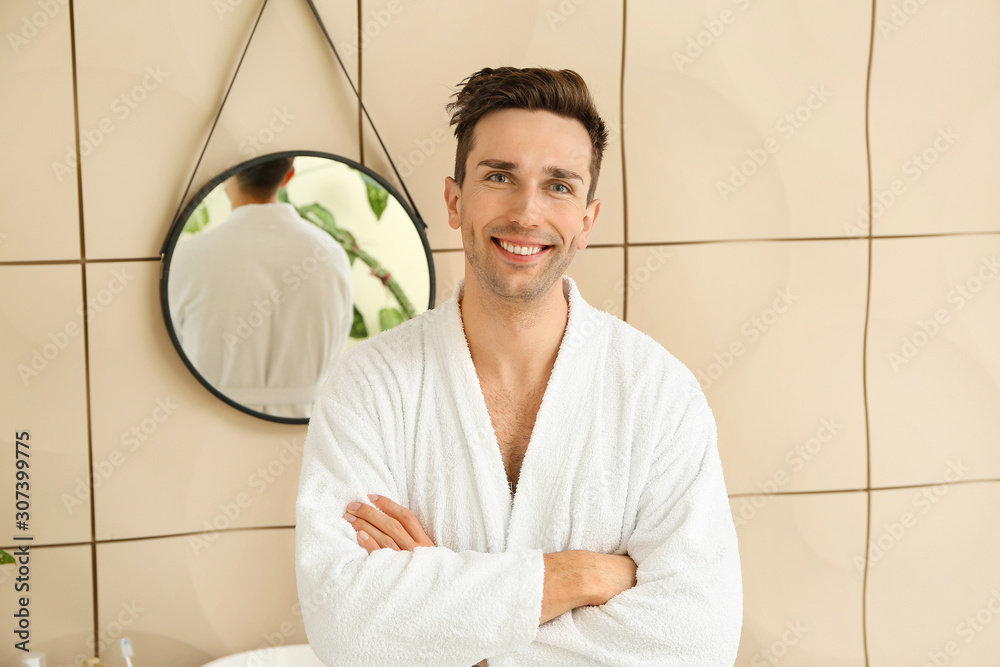 Handsome man after shower in bathroom