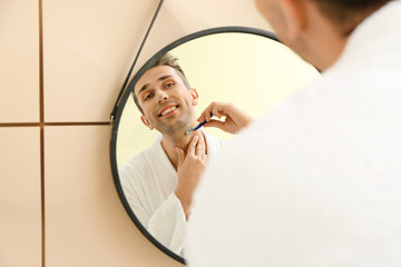 Poster - Handsome man shaving near mirror in bathroom