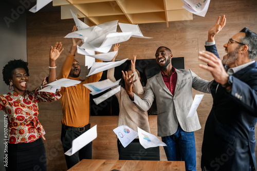 Fotografía Diverse South African business team throwing papers in the air