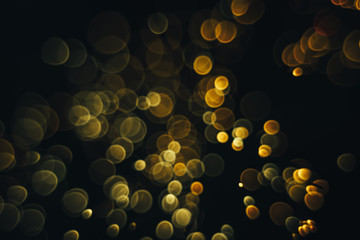 Poster - Beautiful magic gold bokeh background in the darkness.