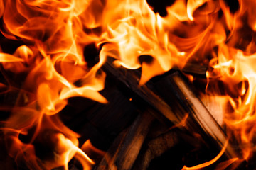 Texture of a flame of fire on a black background. burning fire in a stove closeup