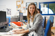 © goodluz - Portrait of businesswoman in office sitting at desk