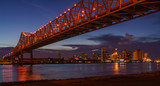 Fototapeta Mosty linowy / wiszący - New Orleans City Skyline, Mississippi River at Night