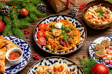 Traditional Uzbek oriental cuisine. Uzbek family table from different dishes for the New Year holiday. The background image is a top view