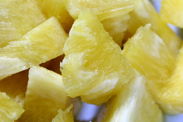 Close up slice pineapple background texture in white dish. Slide and piece of fresh fruit.