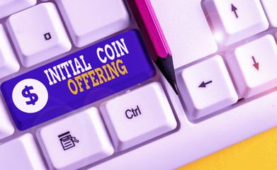 Word writing text Initial Coin Offering. Business photo showcasing crowdfunding using cryptocurrencies raising capital White pc keyboard with empty note paper above white background key copy space