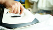 © MODANO - Woman ironing white clothes with a white iron: at home, in the laundry.