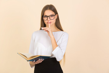 beautiful young woman in glasses with a book in her hands